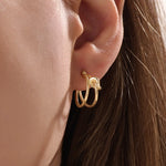 Model wearing 14k gold vermeil knot hoop earrings highlighting their chic, contemporary shape and radiant shine — perfect for both casual and elegant styles.
