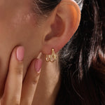 Model wearing 14k gold vermeil knot hoop earrings highlighting their chic, contemporary shape and radiant shine — perfect for both casual and elegant styles.
