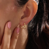 Model wearing 14k gold vermeil knot hoop earrings highlighting their chic, contemporary shape and radiant shine — perfect for both casual and elegant styles.
