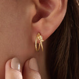 Model wearing 14k gold vermeil knot hoop earrings highlighting their chic, contemporary shape and radiant shine — perfect for both casual and elegant styles.
