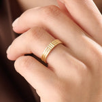 Model wearing a 14k gold vermeil line band ring, showcasing its elegant triple-line design and lustrous golden finish for a timeless minimalist look.
