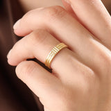 Model wearing a 14k gold vermeil line band ring, showcasing its elegant triple-line design and lustrous golden finish for a timeless minimalist look.
