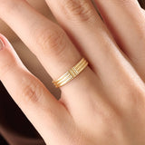 Model wearing a 14k gold vermeil line band ring, showcasing its elegant triple-line design and lustrous golden finish for a timeless minimalist look.
