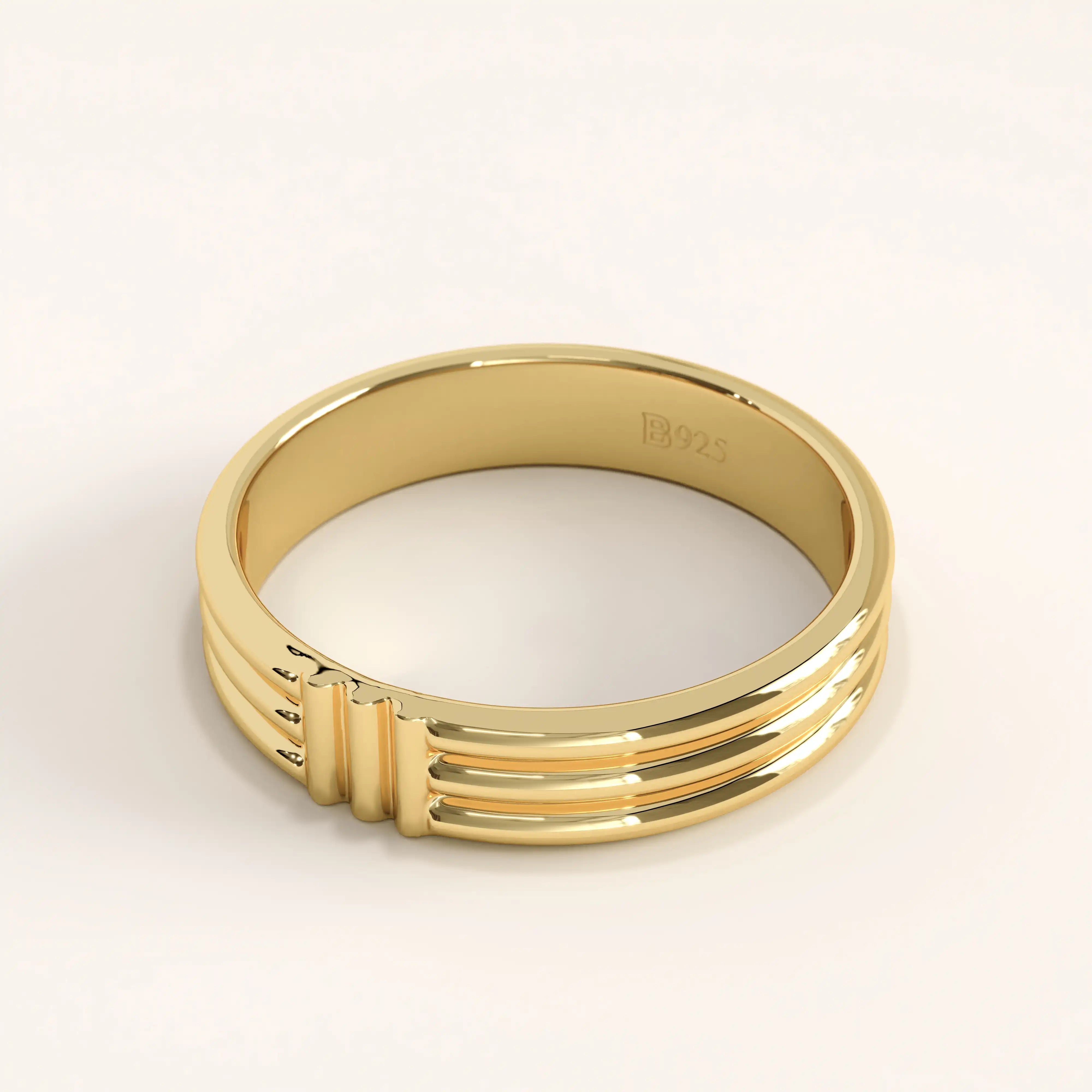 Side angle of 14k gold vermeil line band ring highlighting its structured linear detailing and reflective smooth surface.
