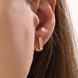 Model wearing 14k gold vermeil line hoop earrings that accentuate their structured design and radiant sheen — perfect for elevating minimalist style.
