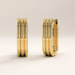 Side view of 14k gold vermeil line hoop earrings highlighting the triple-groove texture and smooth edges for a sophisticated geometric look.
