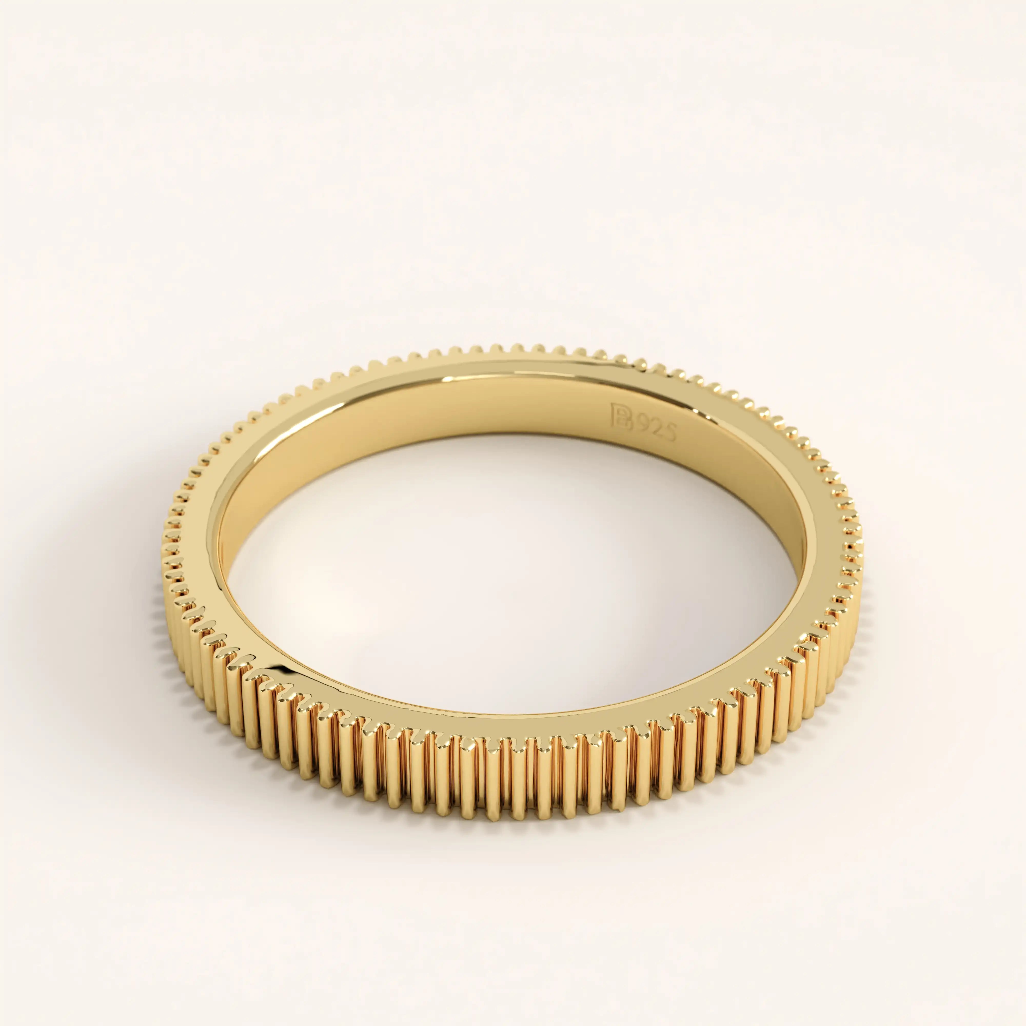 Side view of 14k gold vermeil lined band ring showcasing its refined vertical line detailing and reflective high-shine surface.
