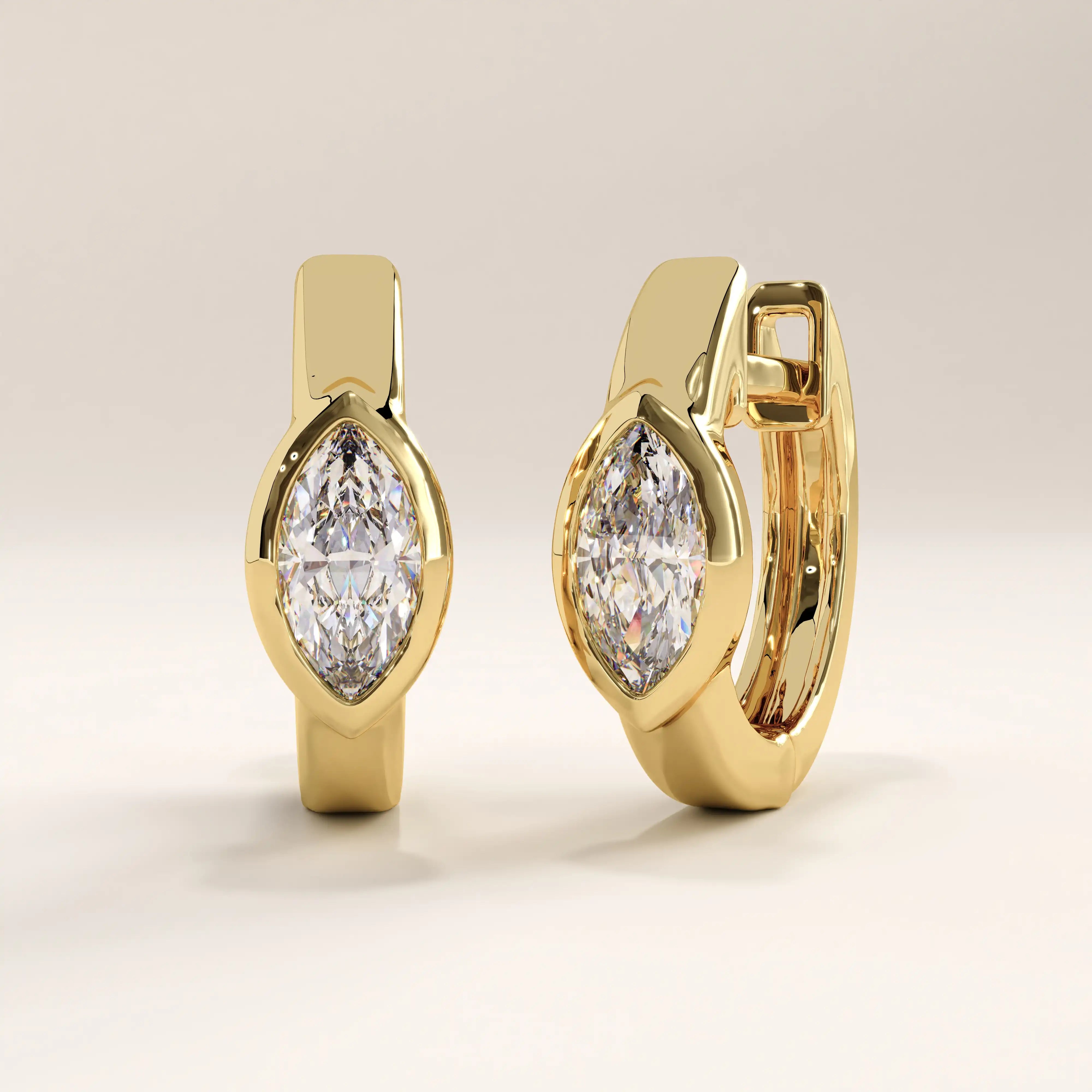 Side view of 14k gold vermeil marquise bezel hoop earrings highlighting the secure hinged closure and smooth contours that enhance comfort and shine.
