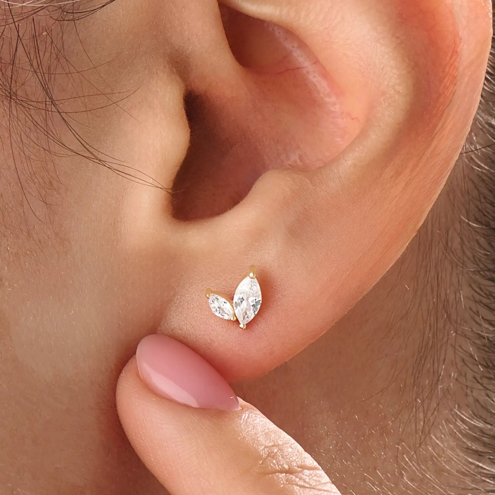 Model wearing 14k gold vermeil marquise leaf earrings showcasing the shimmering marquise-cut stones in a refined, nature-inspired silhouette.
