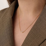 Model wearing a 14k gold vermeil mixed cut necklace featuring a cluster of marquise and round cubic zirconia stones, radiating delicate elegance and everyday glamour.
