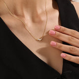 Model wearing a 14k gold vermeil mixed cut necklace featuring a cluster of marquise and round cubic zirconia stones, radiating delicate elegance and everyday glamour.
