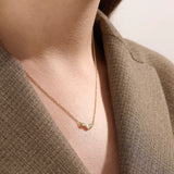 Model wearing a 14k gold vermeil mixed cut necklace featuring a cluster of marquise and round cubic zirconia stones, radiating delicate elegance and everyday glamour.
