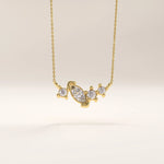 Side view of 14k gold vermeil mixed cut necklace highlighting the intricate stone arrangement and the graceful curvature of the setting that enhances its brilliance.
