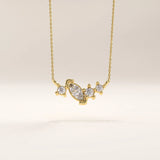 Side view of 14k gold vermeil mixed cut necklace highlighting the intricate stone arrangement and the graceful curvature of the setting that enhances its brilliance.
