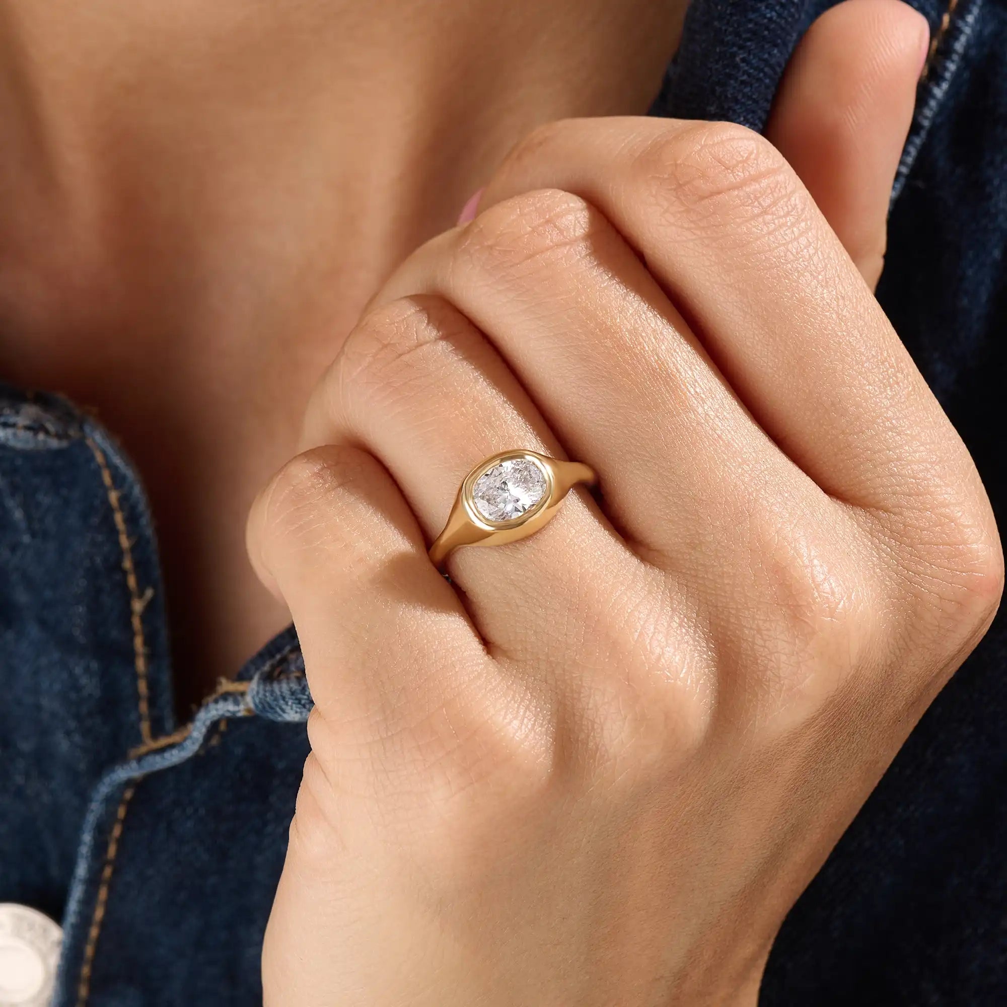 Model wearing a 14k gold vermeil oval-cut dome ring with a sparkling cubic zirconia center stone, creating a bold and refined everyday look.
