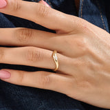 Model wearing a 14k gold vermeil pear curve ring with an elegant sweeping design and a single pear-cut stone for a graceful, luminous finish.

