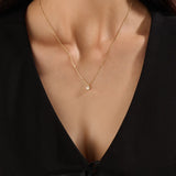 Model wearing a 14k gold vermeil princess solitaire necklace featuring a radiant square-cut cubic zirconia pendant for an understated yet sophisticated sparkle.
