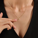 Model wearing a 14k gold vermeil princess solitaire necklace featuring a radiant square-cut cubic zirconia pendant for an understated yet sophisticated sparkle.
