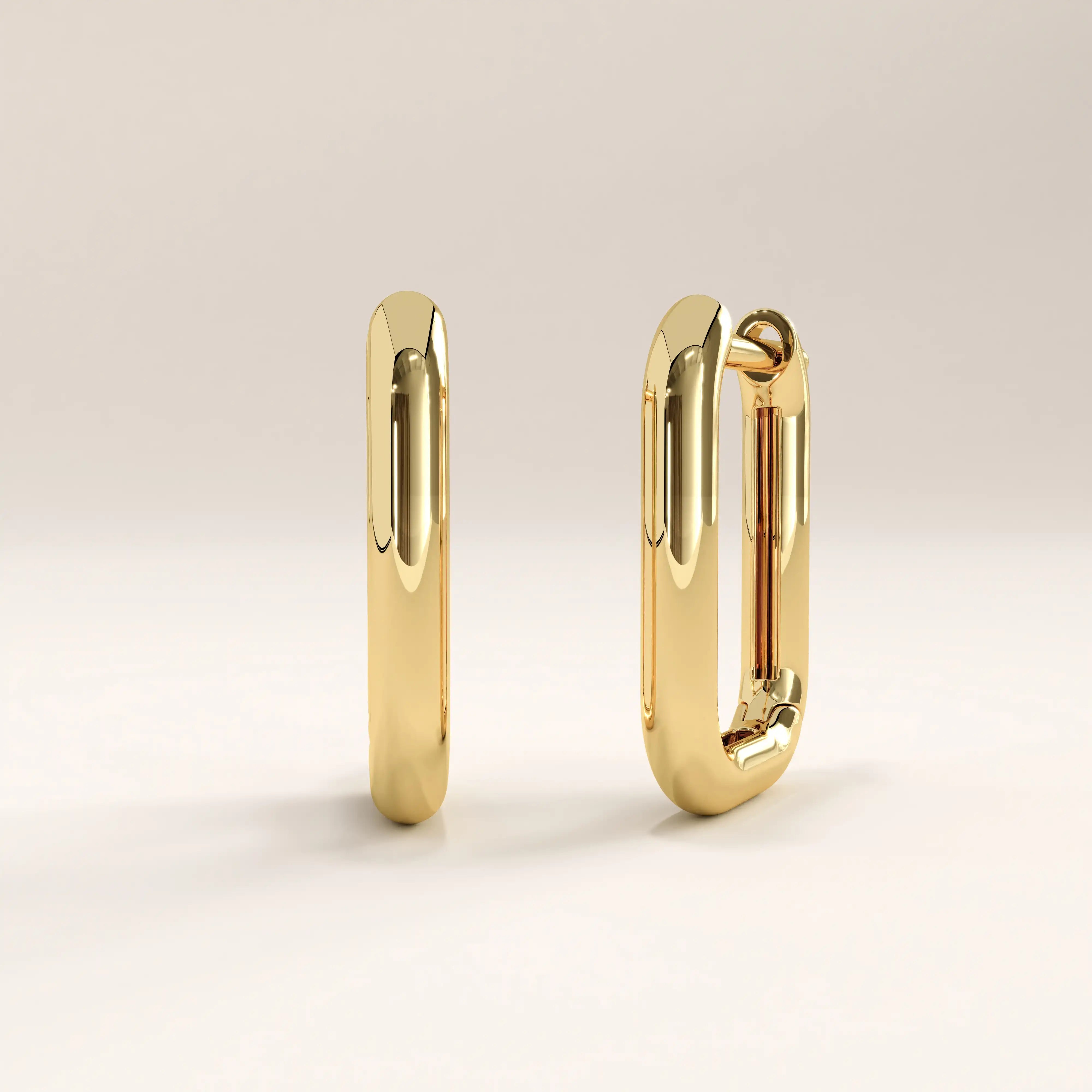 Side view of 14k gold vermeil rectangle hoop earrings showcasing the structured profile and seamless hinge closure for effortless wear.
