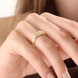 Model wearing a 14k gold vermeil ribbed dome ring showcasing its modern grooved design and bold polished shine for a chic everyday look.
