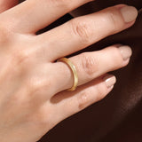 Model wearing a 14k gold vermeil simple band ring, highlighting its slim layered design and radiant gold sheen for a refined modern look.
