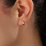 Model wearing 14k gold vermeil solo pear hoop earrings displaying the striking pear-cut gem and sculpted gold finish — perfect for elegant minimalism.
