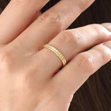 Model wearing a 14k gold vermeil square band ring featuring a faceted pyramid design that catches light beautifully for a sleek, contemporary statement.
