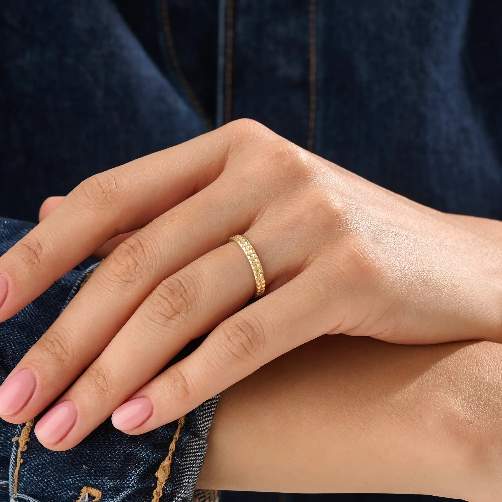 Model wearing a 14k gold vermeil square band ring featuring a faceted pyramid design that catches light beautifully for a sleek, contemporary statement.
