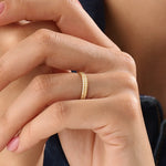 Model wearing a 14k gold vermeil square band ring featuring a faceted pyramid design that catches light beautifully for a sleek, contemporary statement.
