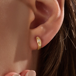 Model wearing 14k gold vermeil star hoop earrings showcasing a luminous gold finish and twinkling stone details, perfect for adding celestial elegance to any outfit.
