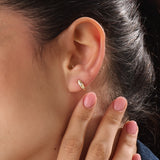 Model wearing 14k gold vermeil star hoop earrings showcasing a luminous gold finish and twinkling stone details, perfect for adding celestial elegance to any outfit.
