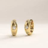 Side view of 14k gold vermeil star hoop earrings highlighting the subtle star engravings and inset stones that catch the light beautifully.
