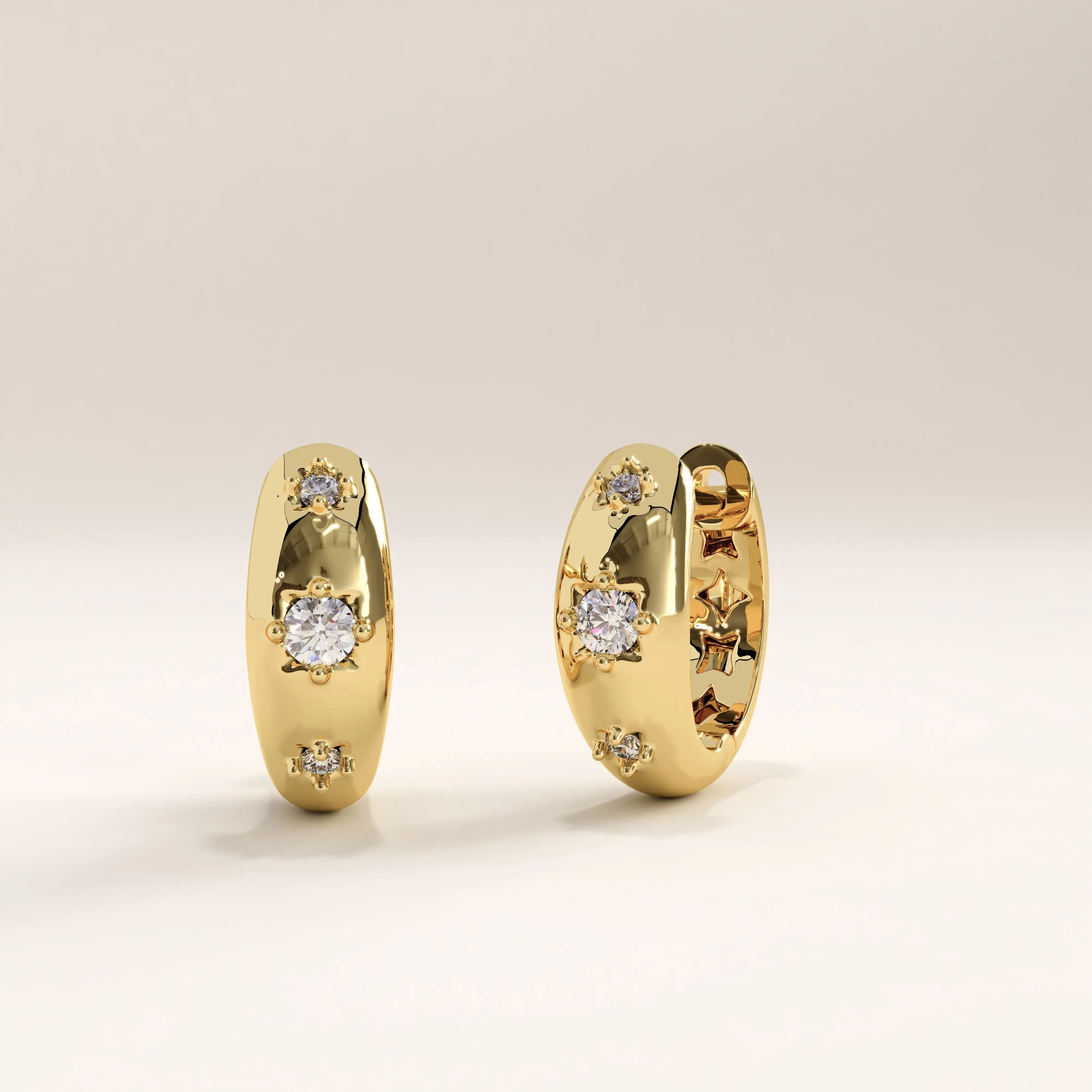 Side view of 14k gold vermeil star hoop earrings highlighting the subtle star engravings and inset stones that catch the light beautifully.
