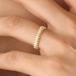 Model wearing a 14k gold vermeil striped ring with its reflective beaded pattern catching the light, adding a refined touch to any look.
