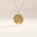 Side view of 14k gold vermeil sunrise coin necklace highlighting the raised sunburst engraving and polished edges for a refined, dimensional finish.
