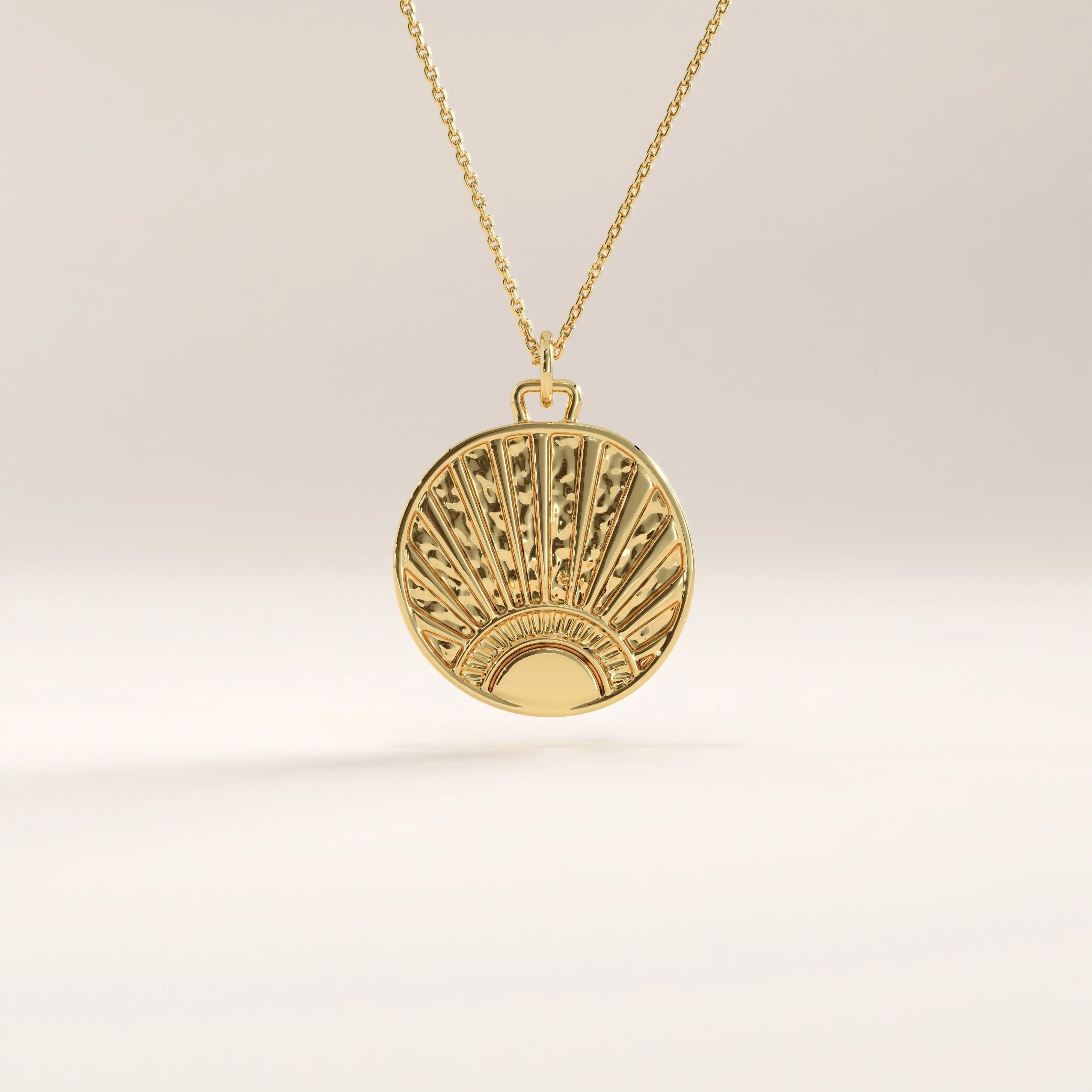 Side view of 14k gold vermeil sunrise coin necklace highlighting the raised sunburst engraving and polished edges for a refined, dimensional finish.
