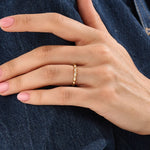 Model wearing a 14k gold vermeil tiny dome ring with softly domed contours, ideal for a timeless and understated everyday style.
 