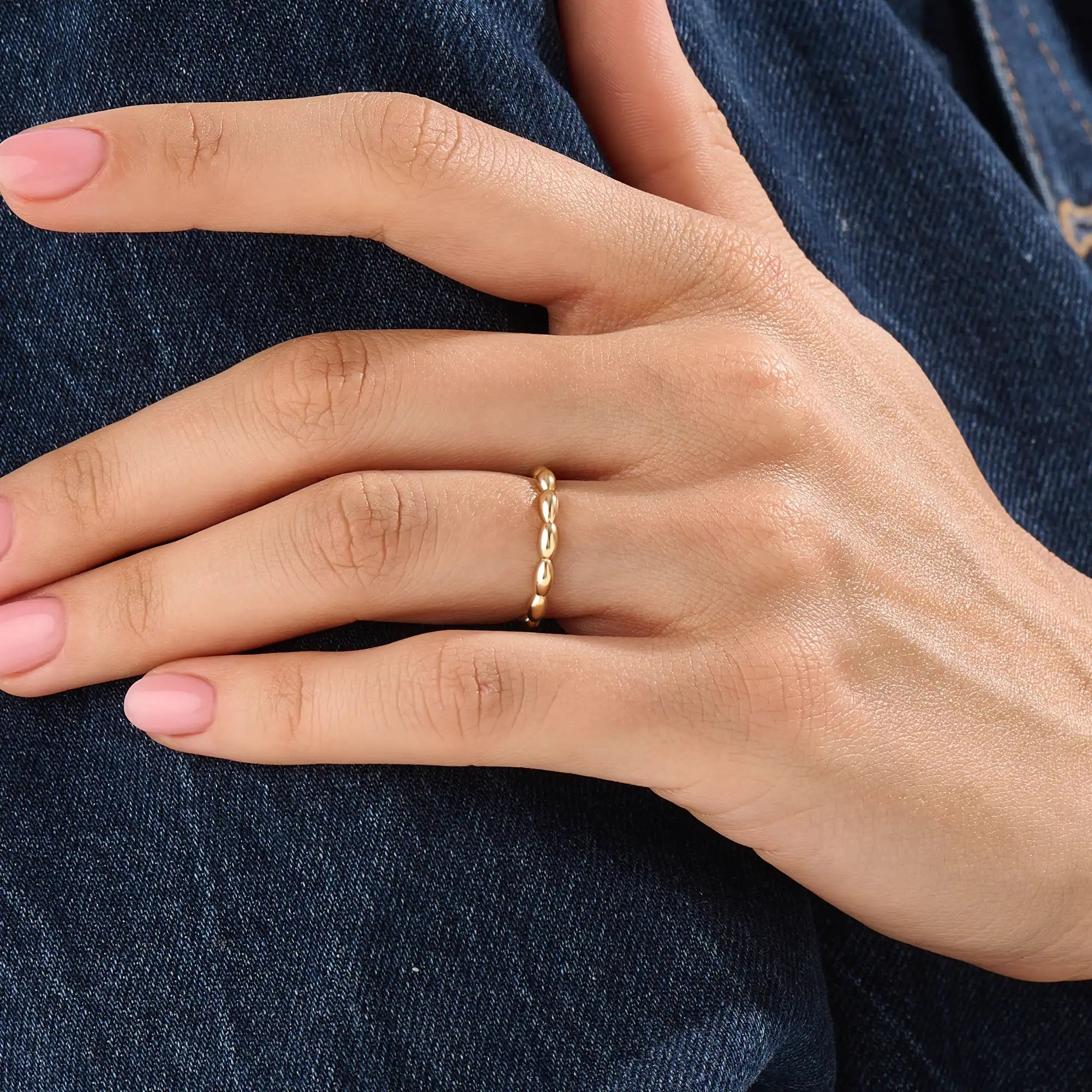 Model wearing a 14k gold vermeil tiny dome ring with softly domed contours, ideal for a timeless and understated everyday style.
 