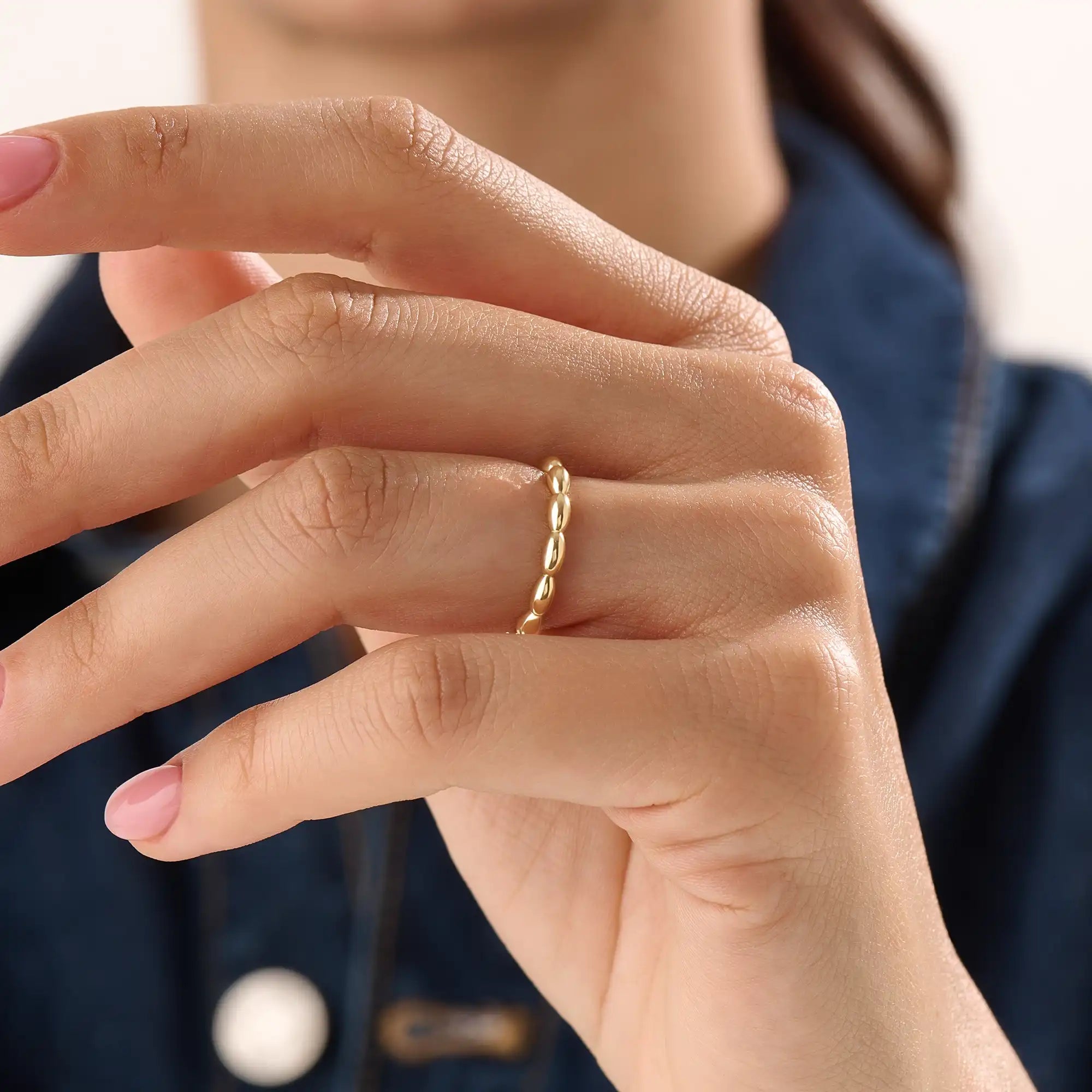 Model wearing a 14k gold vermeil tiny dome ring with softly domed contours, ideal for a timeless and understated everyday style.
