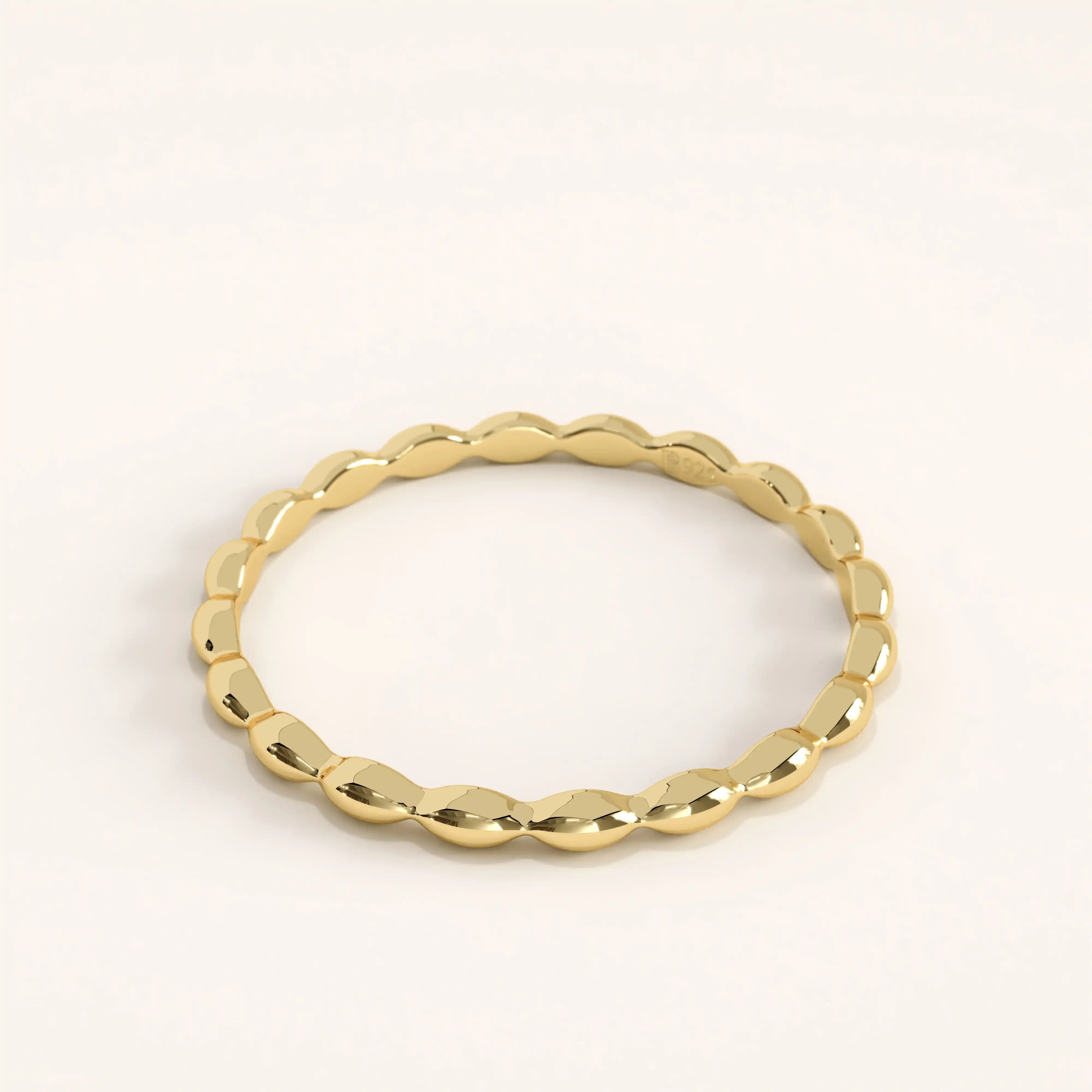 Side view of 14k gold vermeil tiny dome ring showing its gentle curvature and polished dome profile for a refined, lightweight look.
