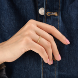 Model wearing a 14k gold vermeil twisted rope ring with a delicate braided design, adding subtle sophistication to any outfit.
