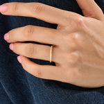 Model wearing a 14k gold vermeil twisted rope ring with a delicate braided design, adding subtle sophistication to any outfit.
