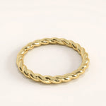 Side angle of 14k gold vermeil twisted rope ring showcasing its smooth interwoven texture and reflective finish.
