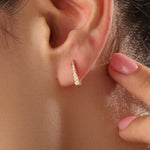 Model wearing 14k gold vermeil U shape hoop earrings that showcase their elegant curvature and radiant sparkle — perfect for both everyday wear and special occasions.
