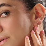 Model wearing 14k gold vermeil U shape hoop earrings that showcase their elegant curvature and radiant sparkle — perfect for both everyday wear and special occasions.
