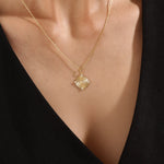 Model wearing a 14k gold vermeil unique round necklace featuring a dimensional circular pendant with radiant concentric rings and cubic zirconia accents for refined brilliance.
