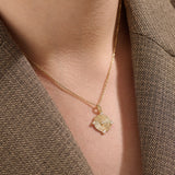 Model wearing a 14k gold vermeil unique round necklace featuring a dimensional circular pendant with radiant concentric rings and cubic zirconia accents for refined brilliance.
