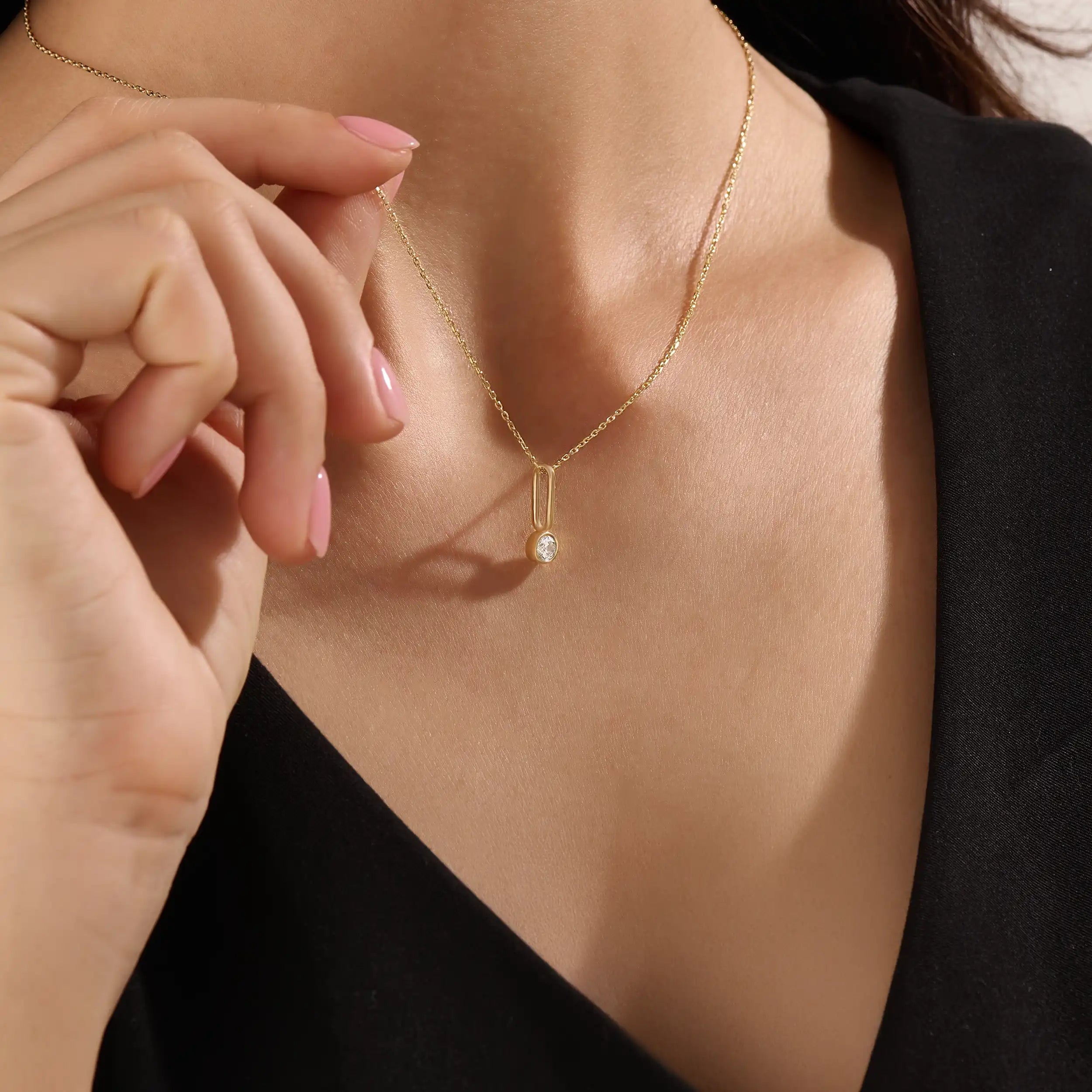 Model wearing a 14k gold vermeil unique solo necklace featuring a delicate chain and minimalist pendant with a single sparkling cubic zirconia, perfect for everyday refinement.
