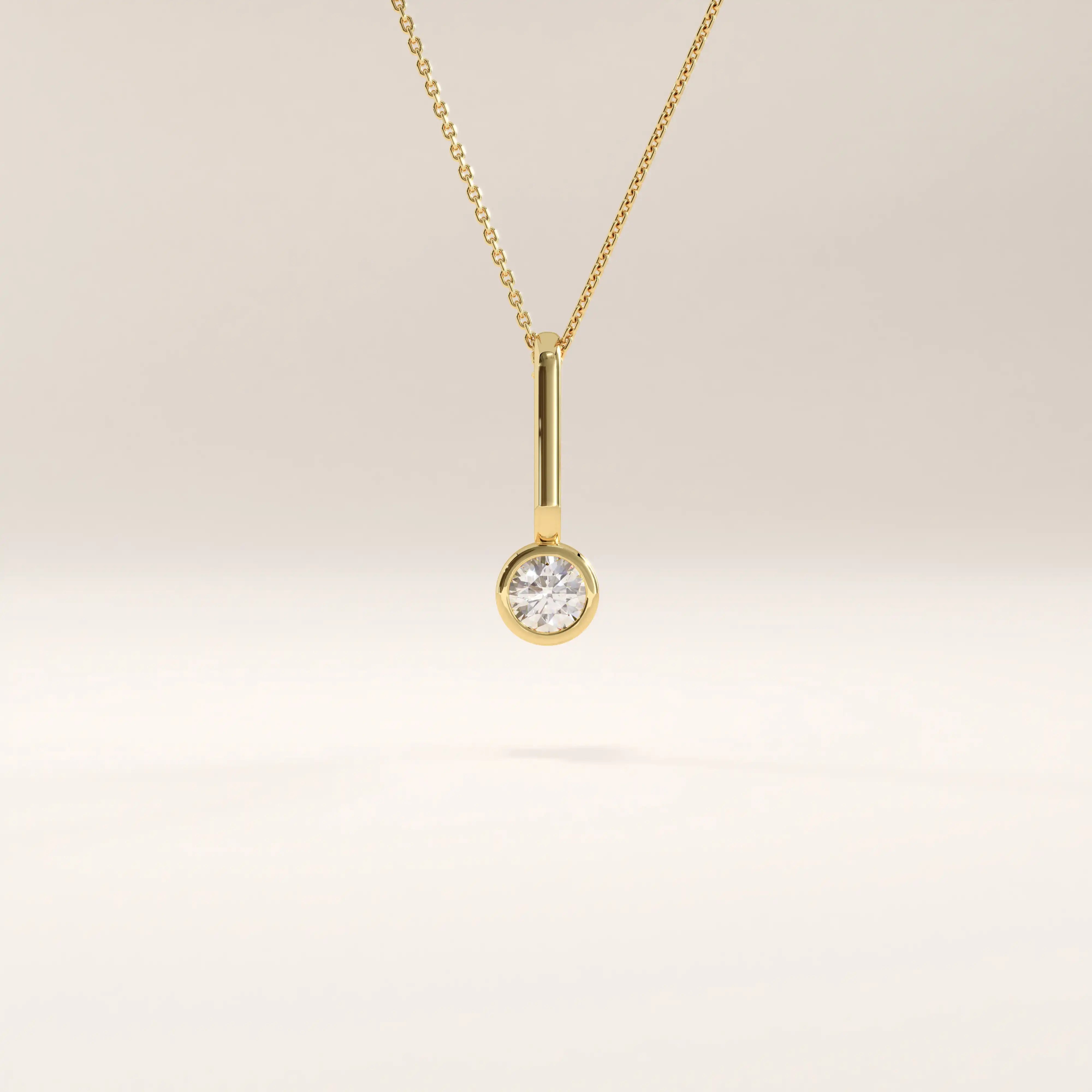 Side view of 14k gold vermeil unique solo necklace highlighting the elongated bail and brilliant round cubic zirconia centerpiece in a clean modern design.
