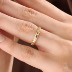 Model wearing a 14k gold vermeil unique wedding band with sculpted facets that reflect light beautifully, blending contemporary style with classic warmth.
